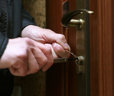 Burglar breaking into house
